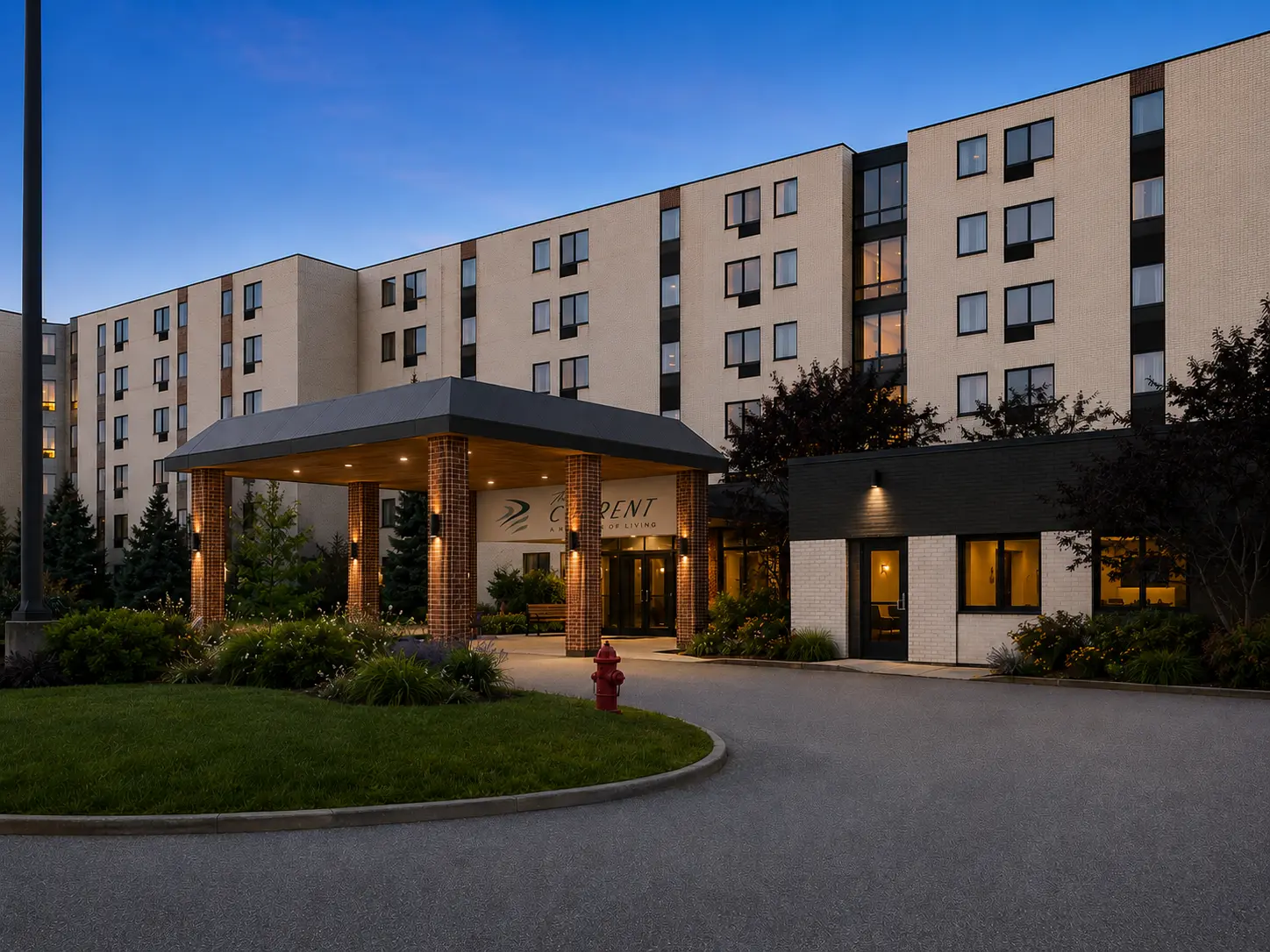 Artist rendering of The Current’s planned illuminated entrance and apartment exterior at dusk